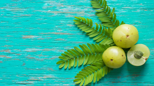 Image of fresh amla fruit, a rich source of vitamin C and commonly used in Ayurvedic medicine, with a greenish-yellow color and smooth, round shape.