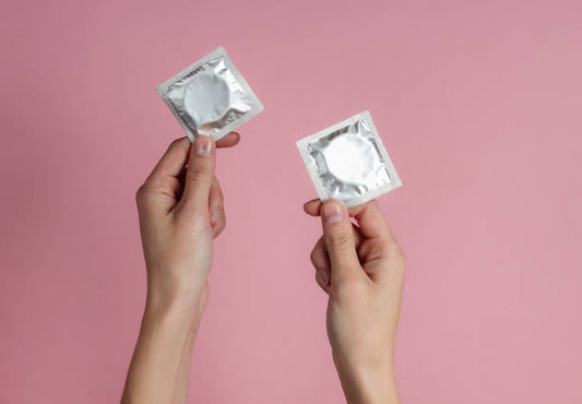 How often should condoms be replaced or checked for expiration dates?