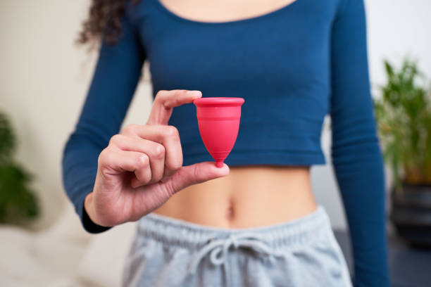 girl holding a menstrual cup